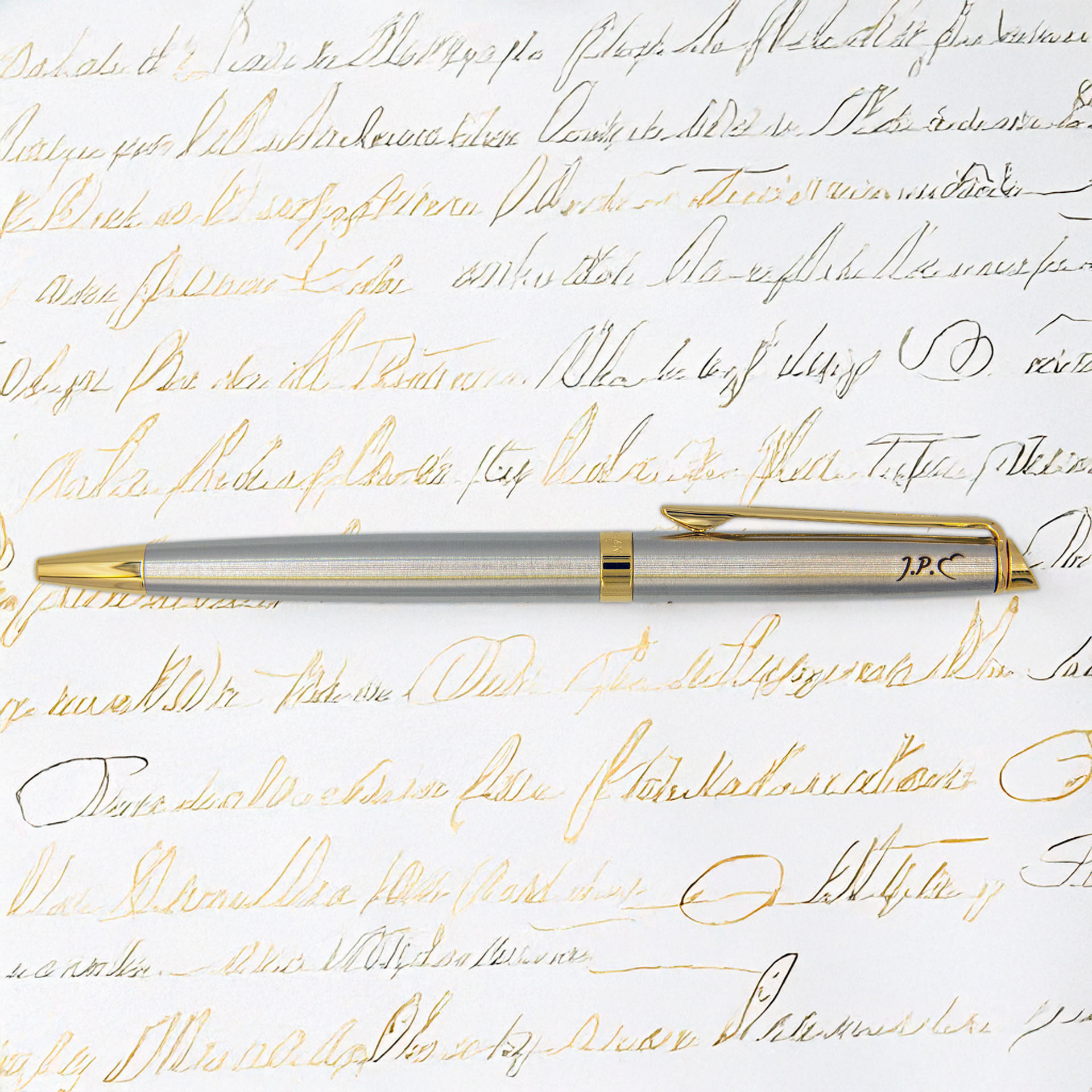 Stylowy długopis Waterman Hemisphere stalowy GT z pozłacanymi wykończeniami na tle kaligrafii